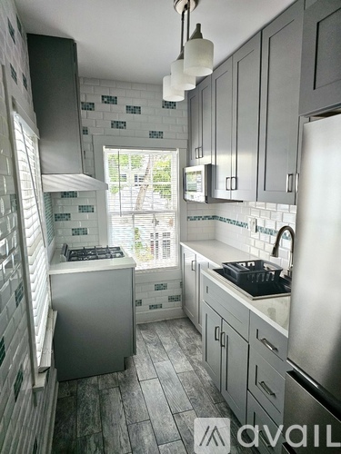 A kitchen with a stove and a refrigerator.
