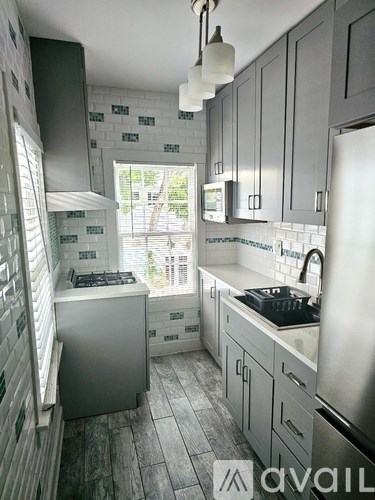 A kitchen with a stove and a refrigerator.
