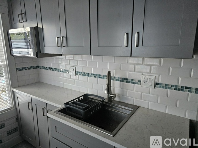 A kitchen with a sink and cabinets.