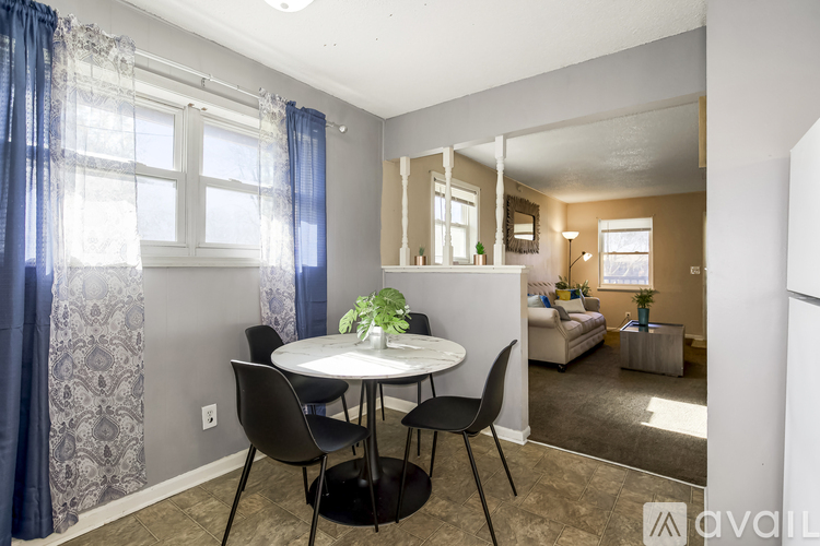 A dining room with a table and chairs.