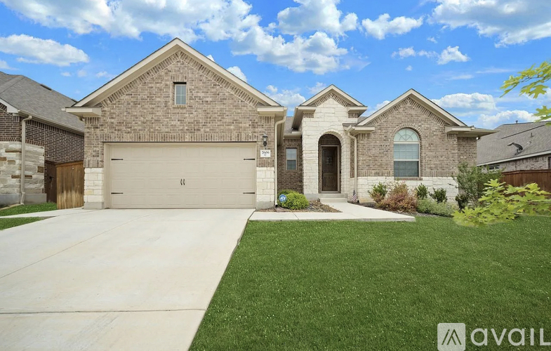 A large house with a driveway in front.