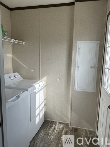 A small laundry room with a washer and dryer.