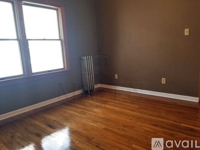 A room with wooden floors and a window.