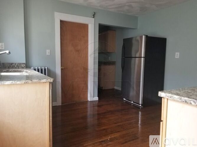 A kitchen with a refrigerator and a counter top.