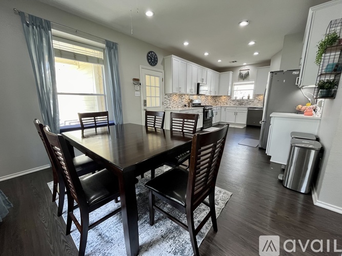 A dining room with a table and chairs is shown.