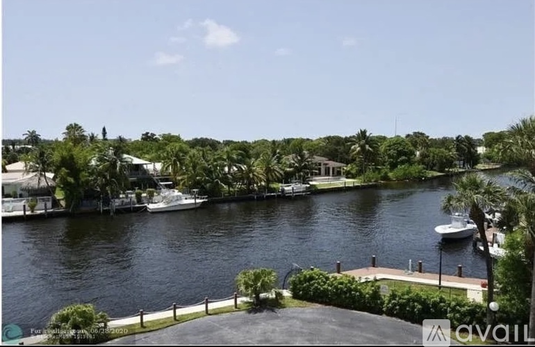 A body of water surrounded by greenery and buildings.