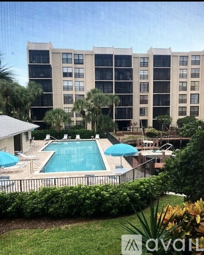 A large building with a pool in front of it.