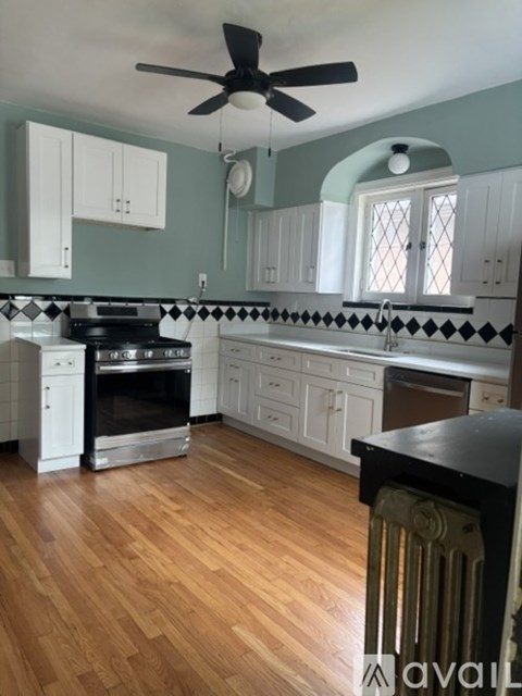 A kitchen with wooden floors and white appliances.