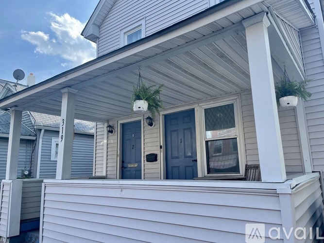 A house with a porch and a blue door.