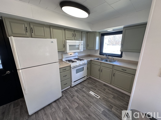 A kitchen with a white refrigerator, a stove, and a microwave.