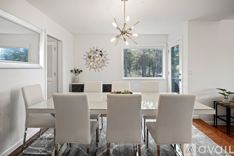 A dining room with a table set for six.