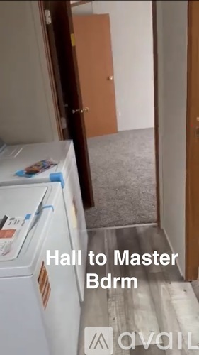 A hallway leading to a master bedroom.