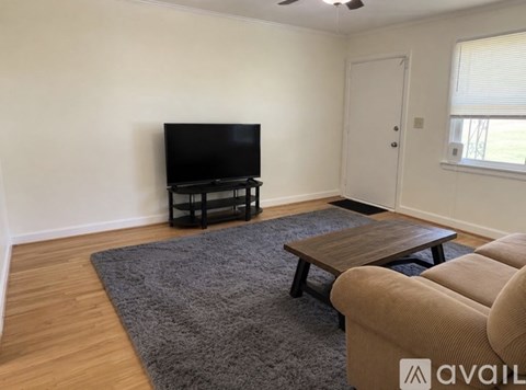 A living room with a television and a couch.