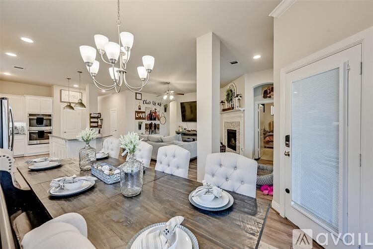 A modern dining room with a wooden table set for a meal.