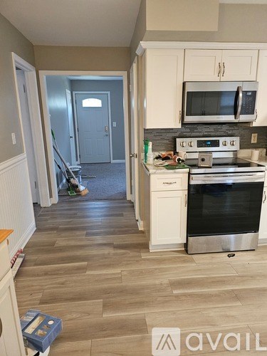 A kitchen with a stove top oven and a microwave above it.