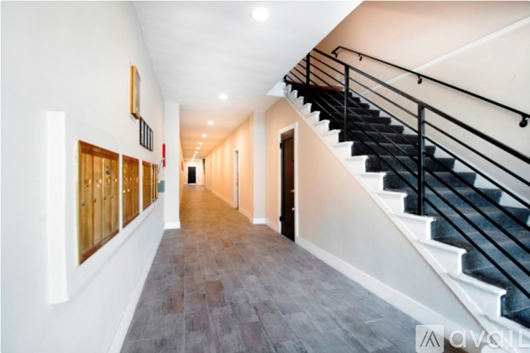 A long hallway with a staircase on the right side.