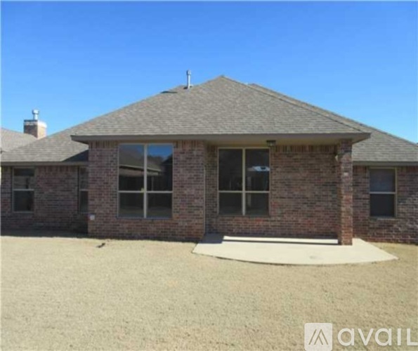 A house with a brown brick exterior and a grey roof.
