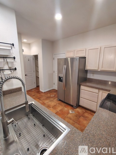 A kitchen with a stainless steel refrigerator and a dishwasher.
