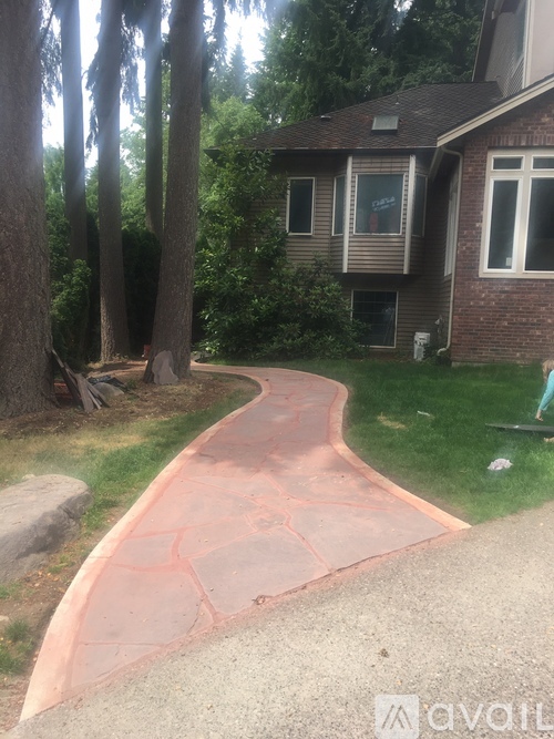 A concrete pathway leads to a house.