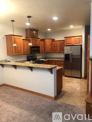 A kitchen with wooden cabinets and a granite countertop.