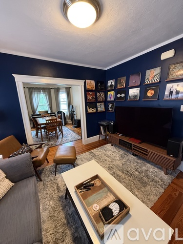 A living room with a grey couch and a wooden coffee table.