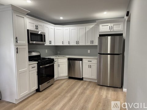 A kitchen with white cabinets and stainless steel appliances.