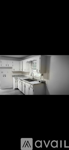 A kitchen with white cabinets and a countertop.