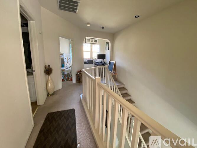 A living room with a staircase leading to the upper floor.