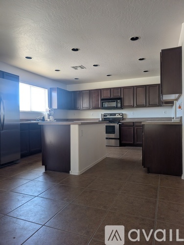 A kitchen with brown cabinets and a white island.