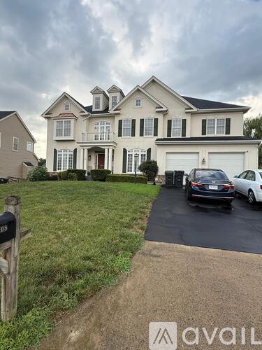 A large house with a car parked in front.