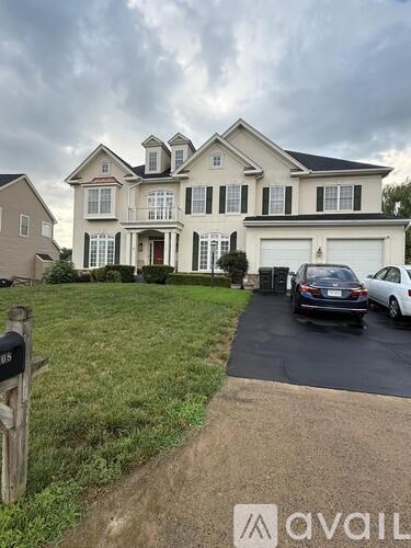 A large house with a car parked in front.