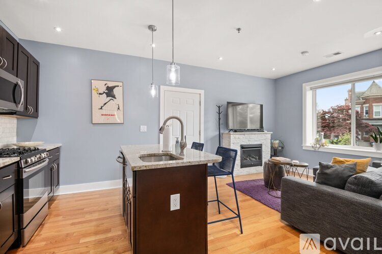 A kitchen with a blue wall and a white door.