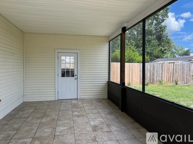 A room with a white door and a tiled floor.