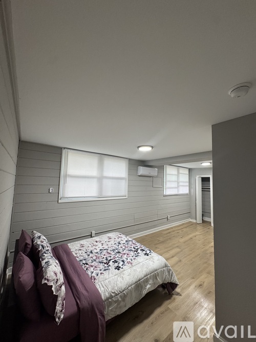 A bedroom with a bed and a window.