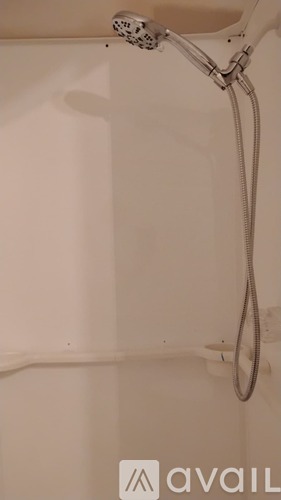 A shower head with a hose attached to it.