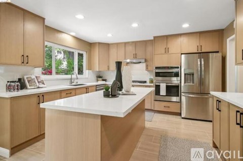 A kitchen with wooden cabinets and stainless steel appliances.