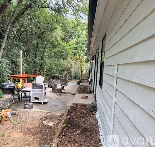 A backyard with a grill and seating area.