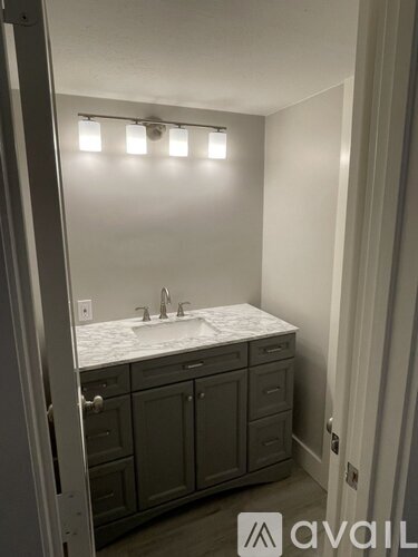 A bathroom with a sink and cabinets.