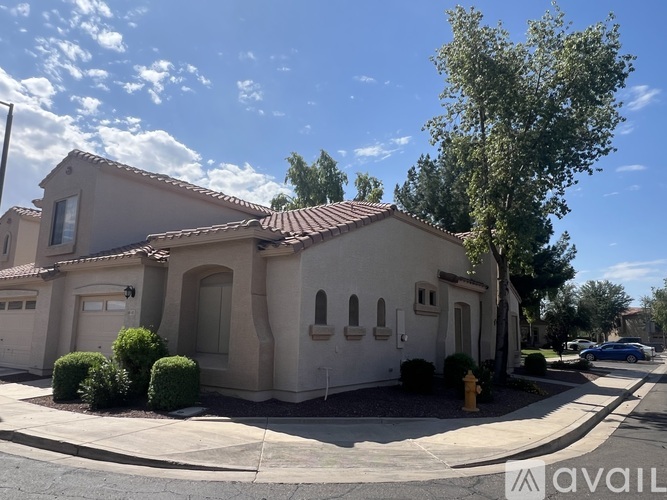 A house with a red tile roof is for sale.