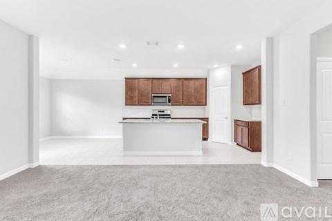 A spacious kitchen with white cabinets and a central island.