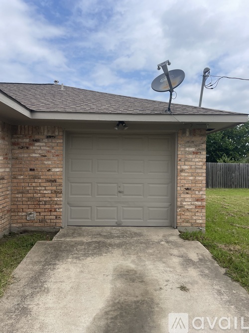 A garage with a satellite dish on the roof.