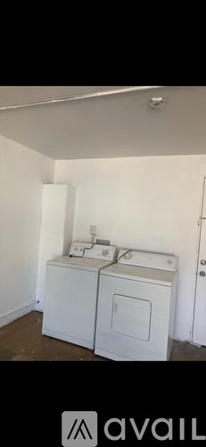 A white washing machine and dryer in a small room.