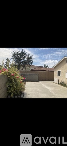 A house with a brown roof and a white garage door.