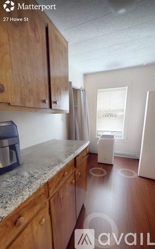 A kitchen with wooden cabinets and a granite countertop.