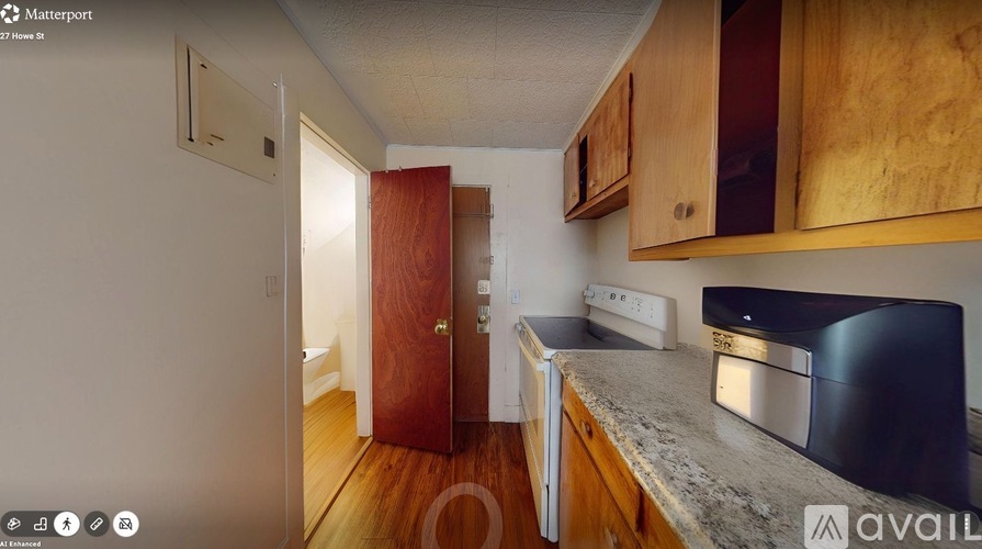 A kitchen with wooden cabinets and a black oven.