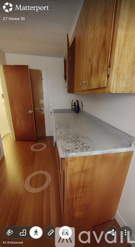 A kitchen with wooden cabinets and a granite countertop.