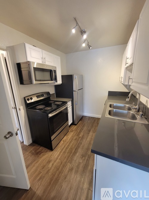 A kitchen with a black oven and stove top.