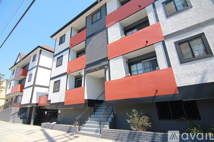 A modern multi-story building with a combination of white, black, and red colors.