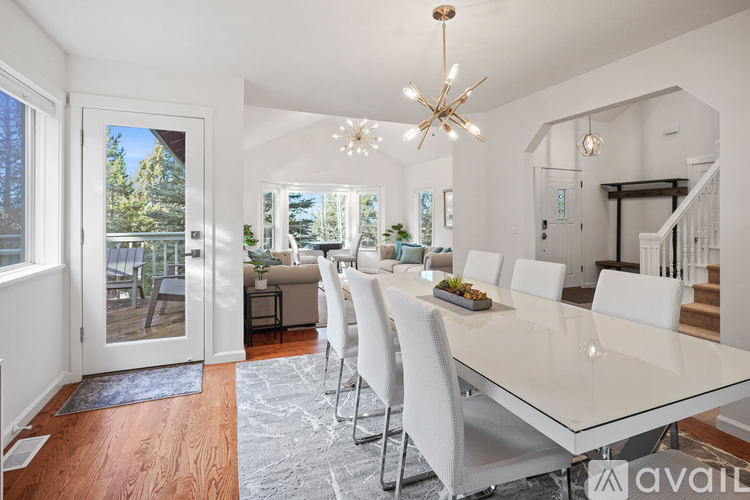A dining room with a long table and chairs.