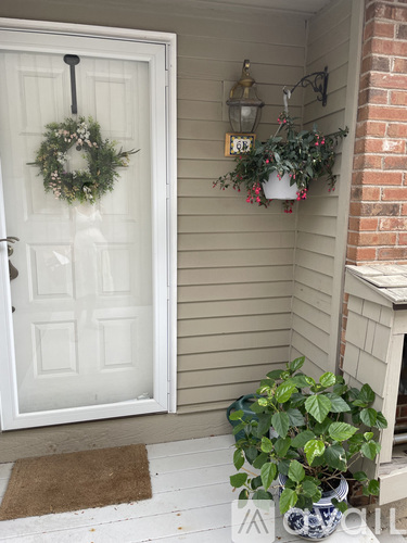 A white door with a wreath on it.